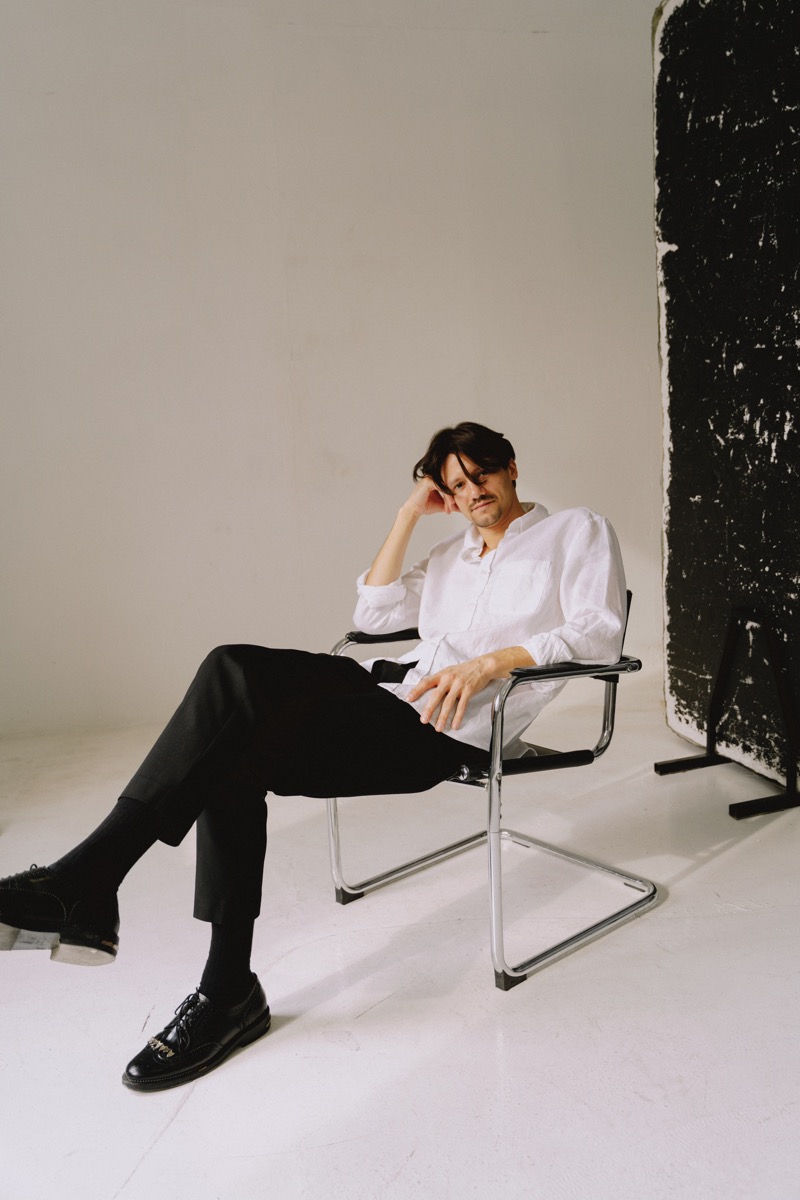 Portrait of Izaak Rodrigo Pereira seated in a studio